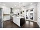 Modern kitchen with stainless steel appliances, white cabinets, and large island at 6616 Aria Village Dr, Atlanta, GA 30328