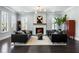 Bright living room featuring a modern fireplace, dark wood floors, and comfortable seating at 6616 Aria Village Dr, Atlanta, GA 30328