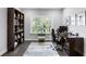 Bright home office with a large window, hardwood floors, and classic furniture at 6616 Aria Village Dr, Atlanta, GA 30328