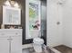 Modern bathroom features a vanity, commode, and walk-in shower with white subway tile and a large window for natural light at 741 Se Knox Se Dr, Atlanta, GA 30315