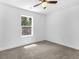 Carpeted bedroom featuring a ceiling fan and natural light from a large window at 741 Se Knox Se Dr, Atlanta, GA 30315