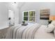 Bright bedroom featuring neutral tones, plush carpet, and a view of the ensuite bathroom at 741 Se Knox Se Dr, Atlanta, GA 30315