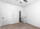 A light-filled bedroom with neutral carpeting, white walls, and a ceiling fan at 741 Se Knox Se Dr, Atlanta, GA 30315