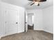 A light-filled bedroom featuring neutral carpeting, ceiling fan, and closet at 741 Se Knox Se Dr, Atlanta, GA 30315