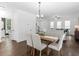 Bright and airy dining area with an adjoining living room, featuring hardwood floors and neutral decor for a welcoming ambiance at 741 Se Knox Se Dr, Atlanta, GA 30315