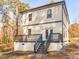 Exterior shot of a two-story home with a deck and stairs in a wooded area at 741 Se Knox Se Dr, Atlanta, GA 30315