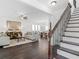 Elegant living room with dark hardwood floors, staircase, and large windows for ample natural light at 741 Se Knox Se Dr, Atlanta, GA 30315