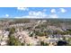 An aerial view shows the suburban neighborhood and surrounding wooded area on a bright, sunny day at 949 Tumlin Trce, Lawrenceville, GA 30045