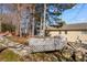 Backyard with stone and wood retaining wall, fire pit, and house at 949 Tumlin Trce, Lawrenceville, GA 30045