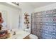 Bathroom featuring decorative shower curtain, open shelving, and a vanity sink at 949 Tumlin Trce, Lawrenceville, GA 30045