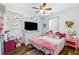 Charming bedroom with pink accents, a TV, and a window with shutters at 949 Tumlin Trce, Lawrenceville, GA 30045