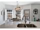 Bright breakfast nook featuring white shutters, an elegant light fixture, and backyard views at 949 Tumlin Trce, Lawrenceville, GA 30045