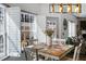 Cozy dining area with a wooden table, white chairs, and natural light from shuttered windows at 949 Tumlin Trce, Lawrenceville, GA 30045