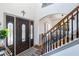 Inviting entryway with a decorative glass door and a staircase with wooden handrails at 949 Tumlin Trce, Lawrenceville, GA 30045