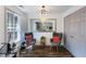 Cozy sitting area with gray chairs, a window with shutters, and wood flooring at 949 Tumlin Trce, Lawrenceville, GA 30045