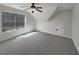 Bedroom with a ceiling fan and a large window providing natural light at 129 Elite Way, Mcdonough, GA 30252