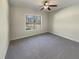 Bedroom with a ceiling fan and a large window providing natural light at 129 Elite Way, Mcdonough, GA 30252