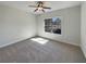 Bedroom with a ceiling fan and a large window providing natural light at 129 Elite Way, Mcdonough, GA 30252