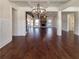 Expansive living room with hardwood floors, coffered ceilings, brick fireplace, and abundant natural light at 129 Elite Way, Mcdonough, GA 30252