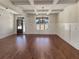 Bright living room showcasing hardwood floors, decorative wall trim, and a stylish chandelier fixture at 129 Elite Way, Mcdonough, GA 30252