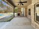 Covered outdoor patio with brick fireplace and ceiling fan, ideal for entertaining guests or enjoying quiet moments at 129 Elite Way, Mcdonough, GA 30252