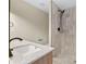 Bathroom featuring a double vanity with decorative mirror and a tiled shower at 19 Grove Park Nw Pl, Atlanta, GA 30318