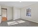 Bedroom with neutral walls, carpeting, and a double door closet with a view to the wood flooring in the hall at 19 Grove Park Nw Pl, Atlanta, GA 30318