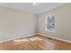 Bedroom with wood flooring, neutral walls and a large window at 19 Grove Park Nw Pl, Atlanta, GA 30318