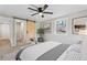 Bright bedroom featuring a ceiling fan, gray walls, a sliding barn door and a beautifully framed window at 19 Grove Park Nw Pl, Atlanta, GA 30318