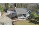 Charming home with a screened-in porch, lush lawn, gray siding, and a detached garage at 19 Grove Park Nw Pl, Atlanta, GA 30318