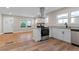 Well-lit kitchen with stainless steel appliances and an island with granite countertop and cabinetry at 19 Grove Park Nw Pl, Atlanta, GA 30318