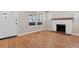 Bright room featuring hardwood floors, a white brick fireplace, and windows for natural light at 19 Grove Park Nw Pl, Atlanta, GA 30318