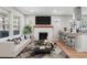Bright living room featuring a decorative fireplace, stylish furniture, and an open concept at 19 Grove Park Nw Pl, Atlanta, GA 30318