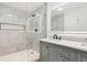 Bathroom features shower, modern light fixtures, a double sink vanity, and neutral tile at 2910 3Rd Sw Ave, Atlanta, GA 30315