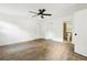 This is a view of a large bedroom with a ceiling fan, wood floors, two doors, and an ensuite bathroom at 2910 3Rd Sw Ave, Atlanta, GA 30315