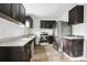 Modern kitchen with dark cabinets, granite countertops and stainless steel appliances at 2910 3Rd Sw Ave, Atlanta, GA 30315