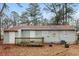 View of the back exterior of the home with a small deck in a private outdoor space at 491 Bolton Nw Rd, Atlanta, GA 30331