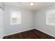 Cozy bedroom featuring two windows for natural light and a closet for storage and dark wood floors at 491 Bolton Nw Rd, Atlanta, GA 30331