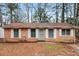 Charming single-story brick home featuring white shutters and mature trees in a quiet neighborhood setting at 491 Bolton Nw Rd, Atlanta, GA 30331