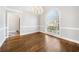 Dining room featuring hardwood floors, chandelier, and a large arched window at 931 New Bedford, Marietta, GA 30068