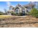 Beautifully landscaped home with well manicured bushes and healthy dormant grass at 931 New Bedford, Marietta, GA 30068