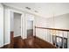 This hallway features gleaming hardwood floors and detailed trim and leads to multiple rooms at 931 New Bedford, Marietta, GA 30068