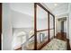 Bright upper hallway with natural light from large windows, dark wood floors and balusters at 931 New Bedford, Marietta, GA 30068