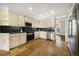 Well-lit kitchen with stainless steel appliances, custom cabinets, and black backsplash at 931 New Bedford, Marietta, GA 30068