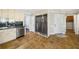 Kitchen featuring stainless steel appliances, custom cabinetry, and doorway to the laundry room at 931 New Bedford, Marietta, GA 30068