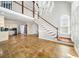 Open living area with staircase, chandelier, and view of the kitchen at 931 New Bedford, Marietta, GA 30068