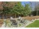 Relaxing backyard featuring a stone patio with chairs and a wooded surround at 435 Collier Nw Rd, Atlanta, GA 30309