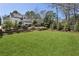 Expansive backyard with manicured lawn, mature trees and home in the background at 435 Collier Nw Rd, Atlanta, GA 30309