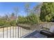 View from the balcony with a seating area overlooking the landscaped backyard and patio at 435 Collier Nw Rd, Atlanta, GA 30309