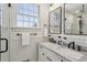 Modern bathroom featuring a double vanity, framed mirrors, and a glass-enclosed shower at 435 Collier Nw Rd, Atlanta, GA 30309